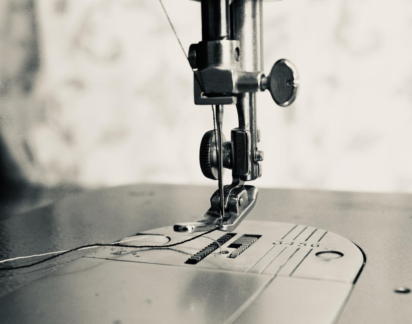 Close-up of a sewing machine needle and presser foot